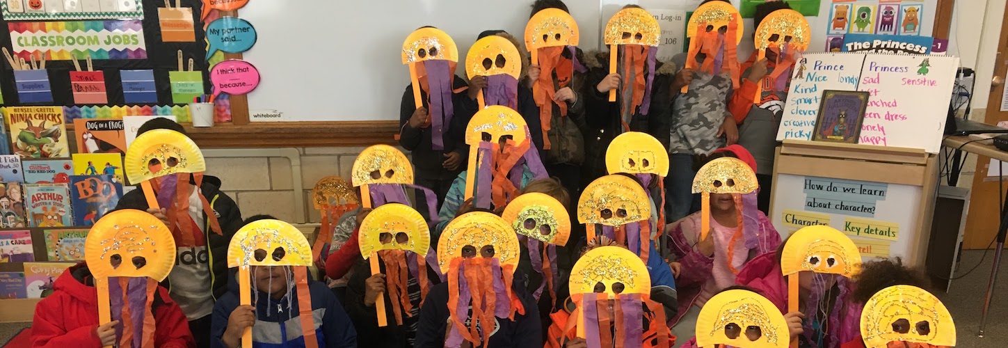 Students posing in class wearing masks