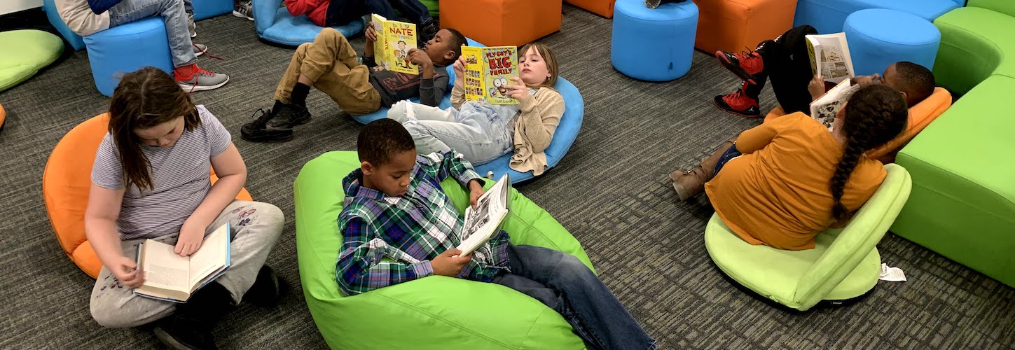 Students reading on bean bags